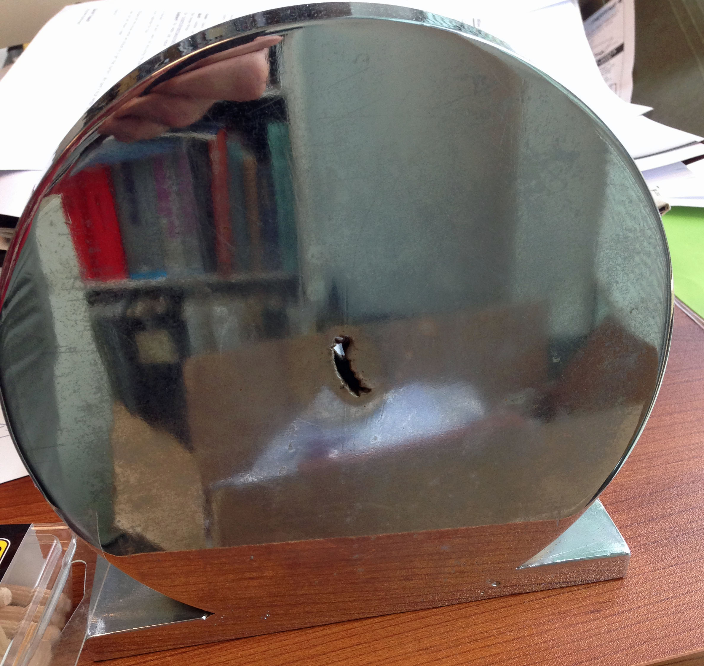 Pipe steel centerline defect in wrought steel bar. We had this specimen hard chrome plated and made it into a bookend.