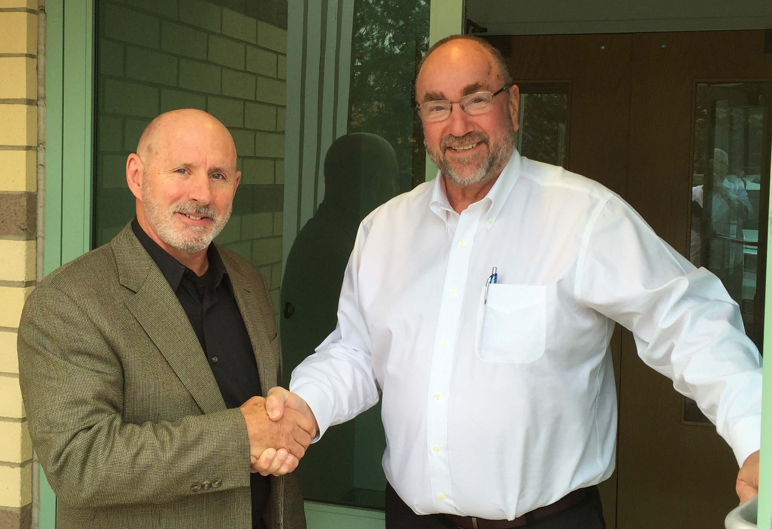 Bernie Nagle (left) is welcomed to PMPA Headquarters by PMPA President Tom Bernstein